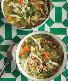 two bowls filled with soup sitting on top of a green and white checkered table cloth