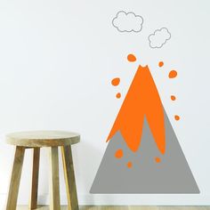 an orange and gray mountain with clouds on it's top is shown in this wall decal