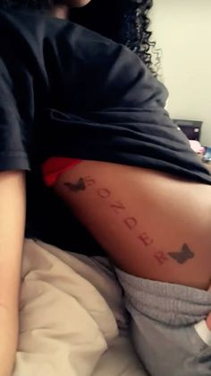 a woman laying on top of a bed with her stomach covered in words and arrows