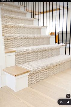 an image of some stairs with carpet on the bottom and bottom steps to the second floor