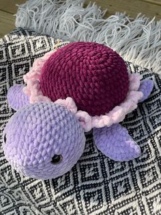 a stuffed animal laying on top of a rug