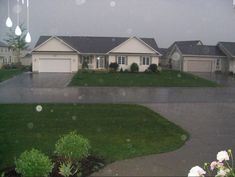 a house is seen through the rain on a cloudy day