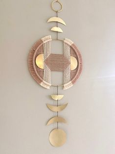 a wall hanging made out of wicker with moon and crescent shapes on it's sides