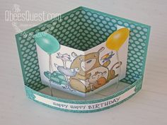 a birthday card in the shape of a box with animals on it and balloons attached