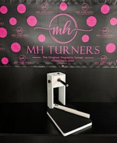 a black counter top with pink polka dots on it and a sign that says m & w