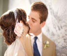 the bride and groom are kissing each other