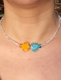 Fish Necklace with Murano Glass is a Handmade Candy Choker adorned with Rainbow Color Changing Crystals, featuring Pink, Blue, Green, and Orange Fish Variants. You will receive 1 necklace. 👀Discover Similar Murano Jewelries https://www.etsy.com/shop/demetergemart/?etsrc=sdt§ion_id=44661532 🙌SATISFACTION ♥ Your satisfaction is our top priority. ♥ We want you to absolutely love your purchase, which is why we've made our return process incredibly simple. ♥ If, for any reason, you receive your ite Murano Necklace, Simple Beaded Necklaces, Crystals Pink, Murano Jewelry, Handmade Candy, Orange Fish, Fish Jewelry, Murano Glass Jewelry, Fish Necklace