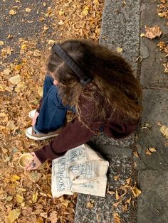 a woman sitting on the ground with her head down