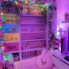 a room with pink and purple lights, bookshelves filled with cartoon characters and plants