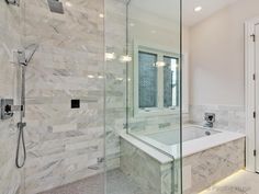 a large bathroom with marble walls and flooring