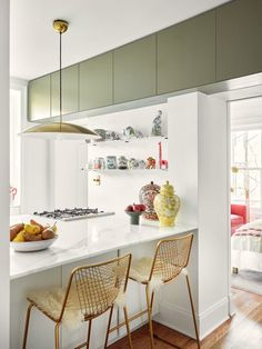 two chairs are sitting at the kitchen island