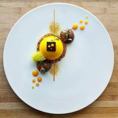 a white plate topped with a dessert on top of a wooden table