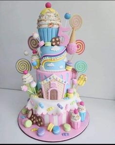 this is a cake made to look like a candy land tower with lots of candies and lollipops