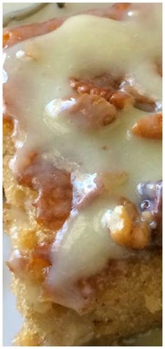 a close up of food on a plate with white icing and nuts in it