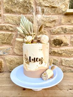 a white cake sitting on top of a blue plate next to a brick wall and wooden table