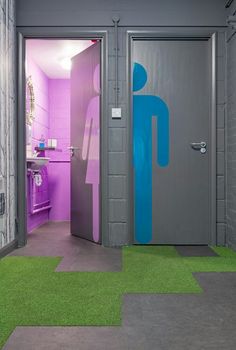 an open door to a bathroom with green and purple carpeting on the floor in front of it