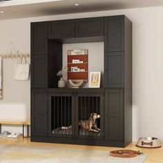 a dog is laying in its cage on the floor next to a wall mounted cabinet