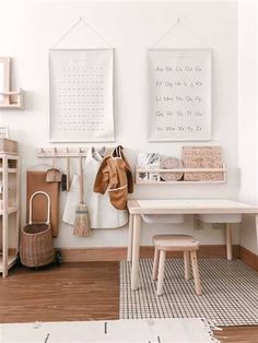 a white room with wooden floors and various items hanging on the wall, including a coat rack