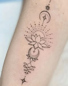 a black and white photo of a tattoo on the arm with stars, crescents and moon