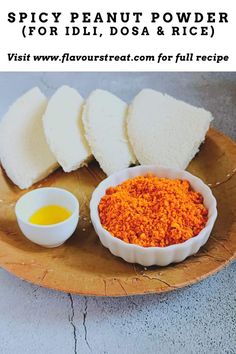 the ingredients for spicy peanut powder on a wooden plate with text overlay that reads spicy peanut powder for idli, dosa & rice