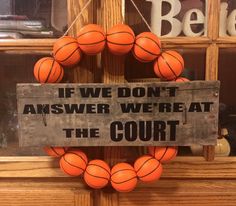 a sign that says if we don't answer we treat the court, basketball wreath