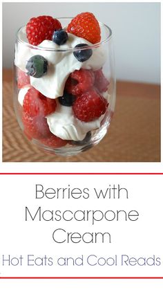 berries with mascarpone cream in a glass bowl on top of a wooden table