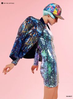 a person wearing a hat and dress with colorful sequins on it's back