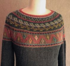 a mannequin wearing a sweater with multicolored patterns