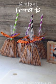 two bags of pretzel broomsticks sitting next to each other on a table