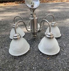 three light fixtures sitting on the ground next to each other