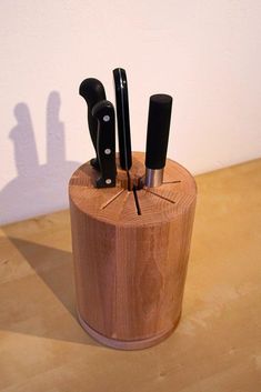 the knife holder is made out of wood and has four knives in it's center