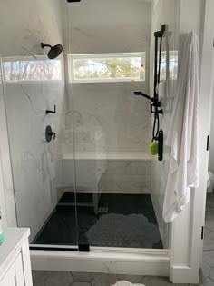 a walk in shower sitting inside of a bathroom