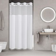 a bathroom with a sink, mirror and shower curtain in it's center area