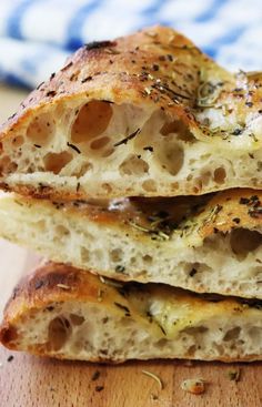 three pieces of bread stacked on top of each other with herbs sprinkled on them