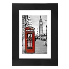 a black and white photo of a red phone booth