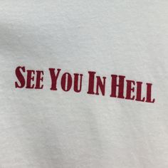 the word see you in hell is printed on a white t - shirt with red lettering