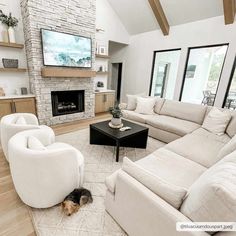 a living room filled with furniture and a flat screen tv mounted on the wall above a fireplace