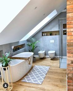 a bathroom with a large bathtub next to a toilet