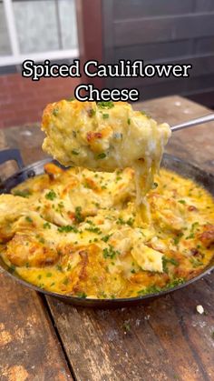 a close up of a plate of food on a table with the words spiced cauliflower cheese