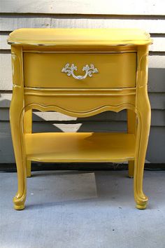 a yellow table with two drawers on it