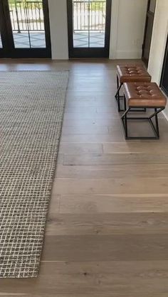 an empty living room with wood flooring and sliding glass doors