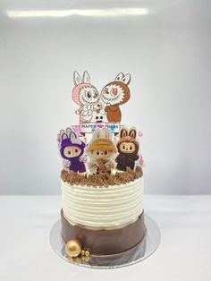 a three tiered cake with cartoon characters on it