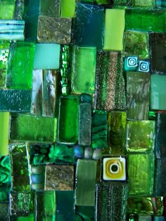 a close up view of green glass tiles