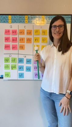 a woman standing in front of a bulletin board