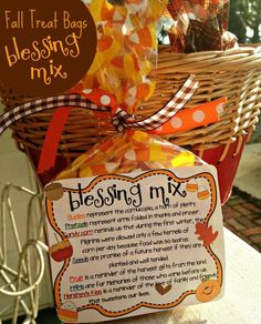 a basket filled with lots of candy sitting on top of a table next to a sign that says blessing mix