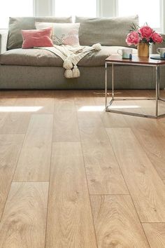 a living room filled with furniture and a large wooden flooring piece on top of a hard wood floor