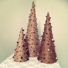 three small christmas trees are on a table