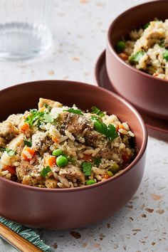 two brown bowls filled with rice and vegetables