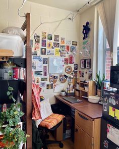 a bedroom with a bed, desk and computer on the wall next to a window