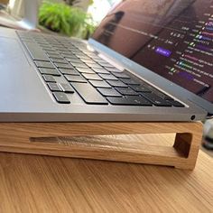 an open laptop computer sitting on top of a wooden desk